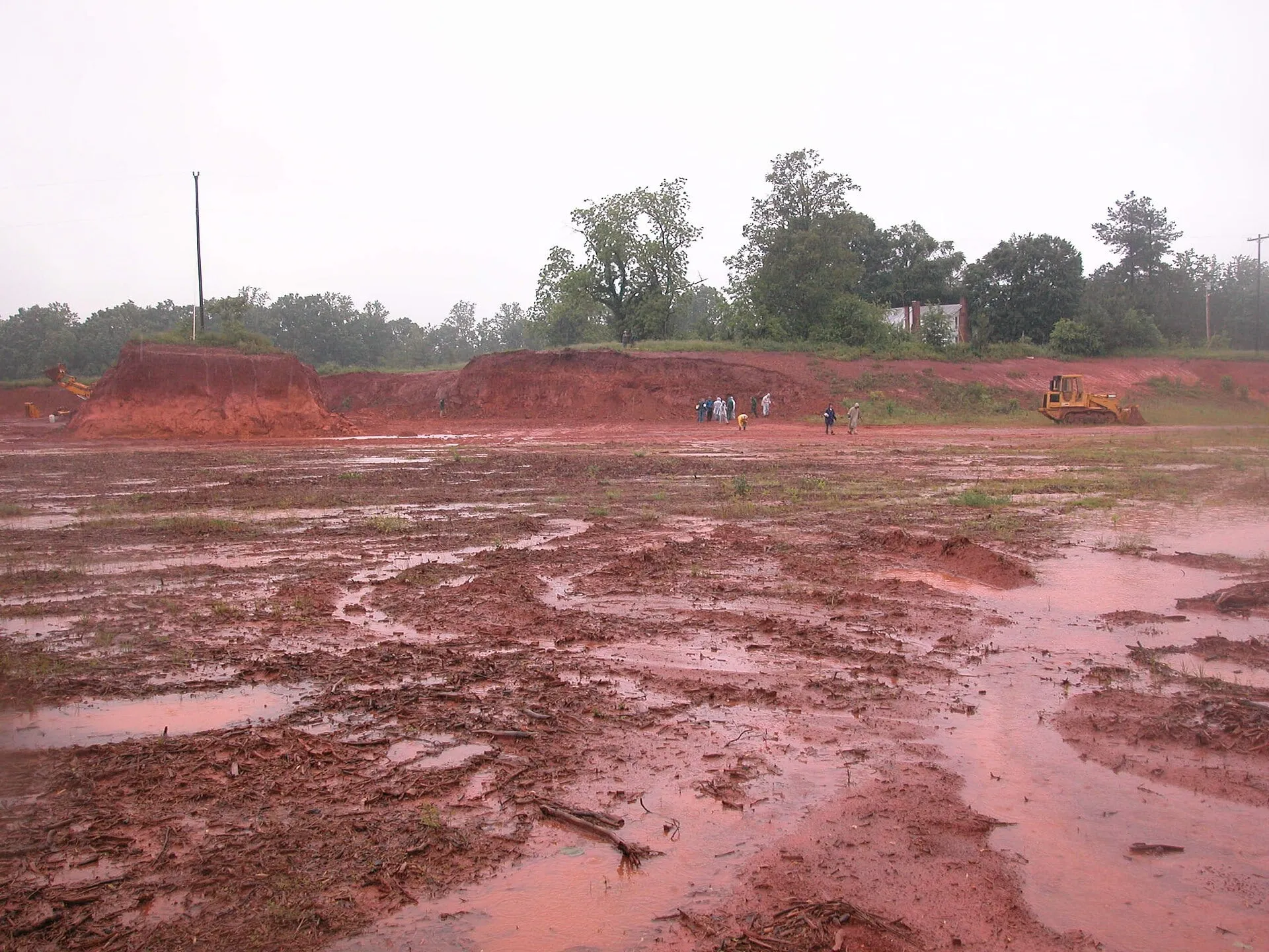 A wet, graded red clay building site